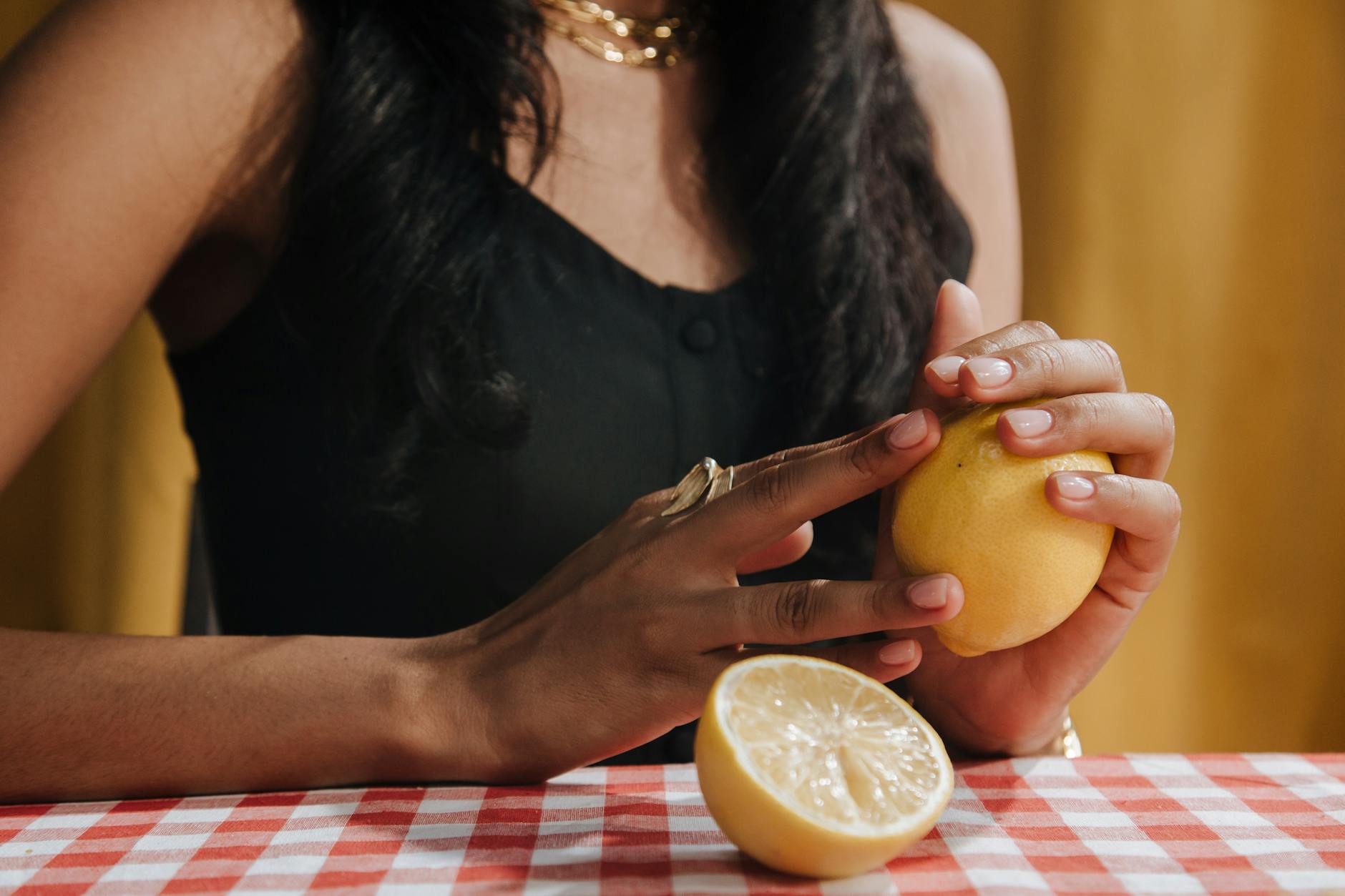 A yellow silicone vibrator surrounded by fresh fruit on a yellow background, representing natural pleasure for aging bodies.