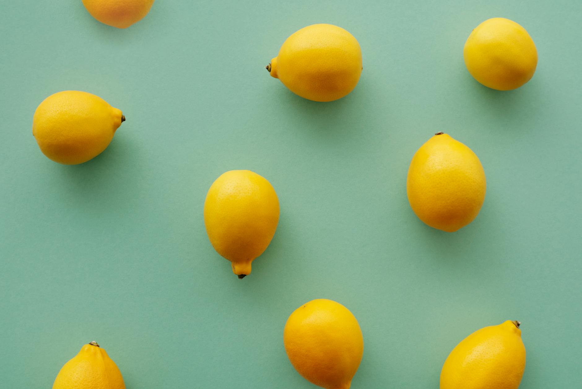Bright yellow lemons arranged on a pastel background, symbolizing fresh approaches to sexual wellness
